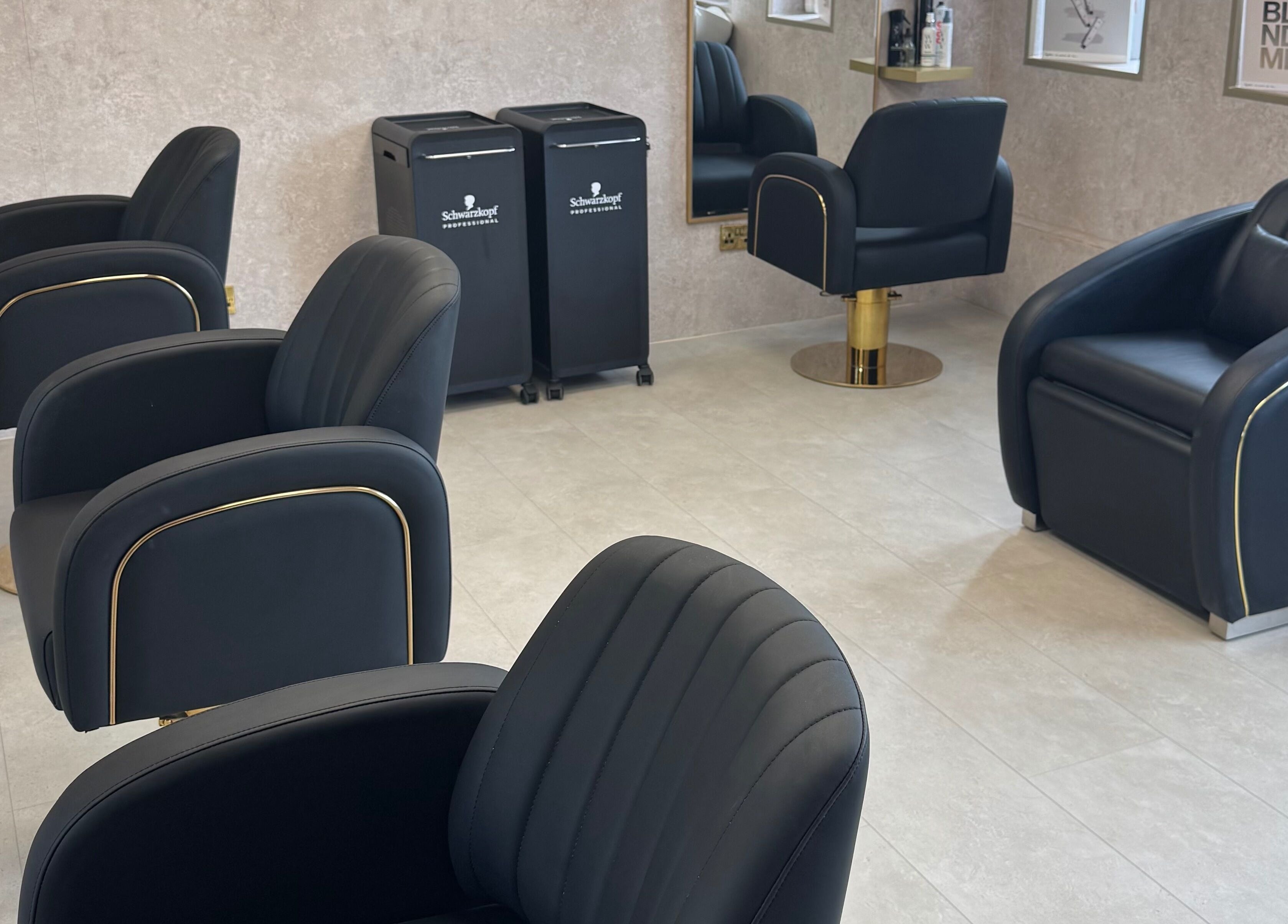 Stylish seating at The Hair Edit by caitlin- at Solea Salon, Motherwell, Scotland, GB, featuring modern black chairs.