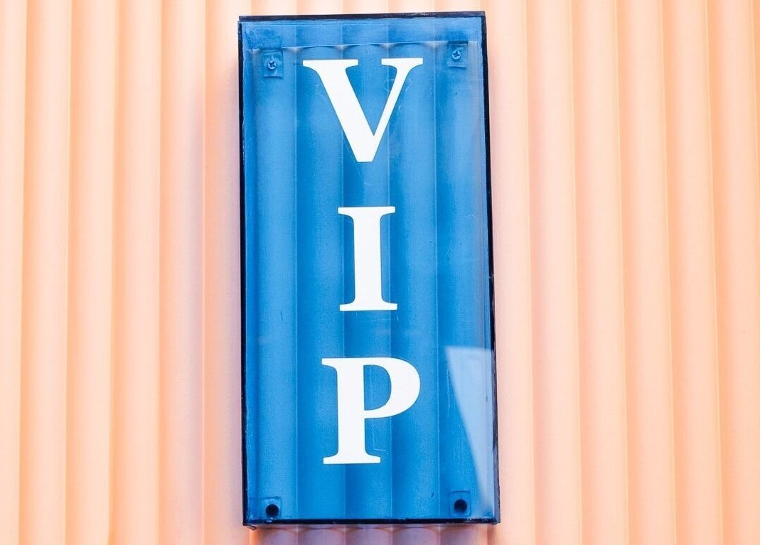 Blue 'VIP' sign at Lunch Break Beauty in Makati, Metro Manila, PH against a peach background.