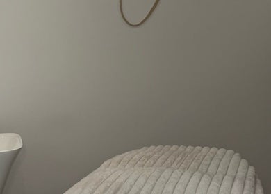 Tranquil treatment room at Skin Orchid, London, England, GB, featuring a plush treatment bed and ambient decor.