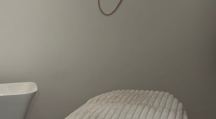Tranquil treatment room at Skin Orchid, London, England, GB, featuring a plush treatment bed and ambient decor.