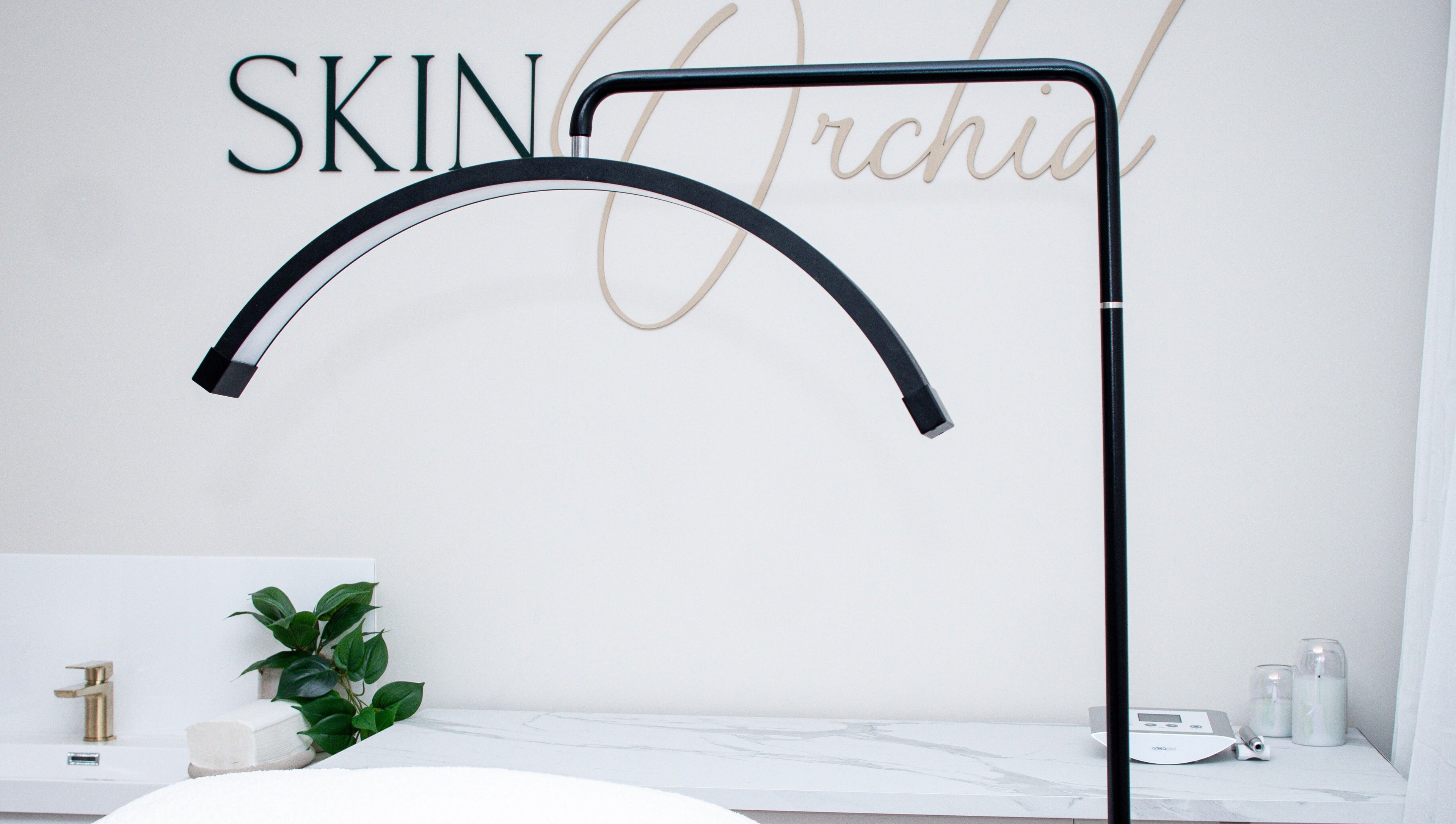 Sleek modern treatment area at Skin Orchid, London, England, GB, featuring spa essentials and a serene ambiance.