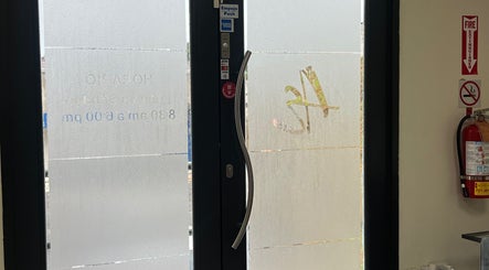 Entrance door of Advance Esthetic in San Lorenzo, San Lorenzo, PR with glass and curved handle.