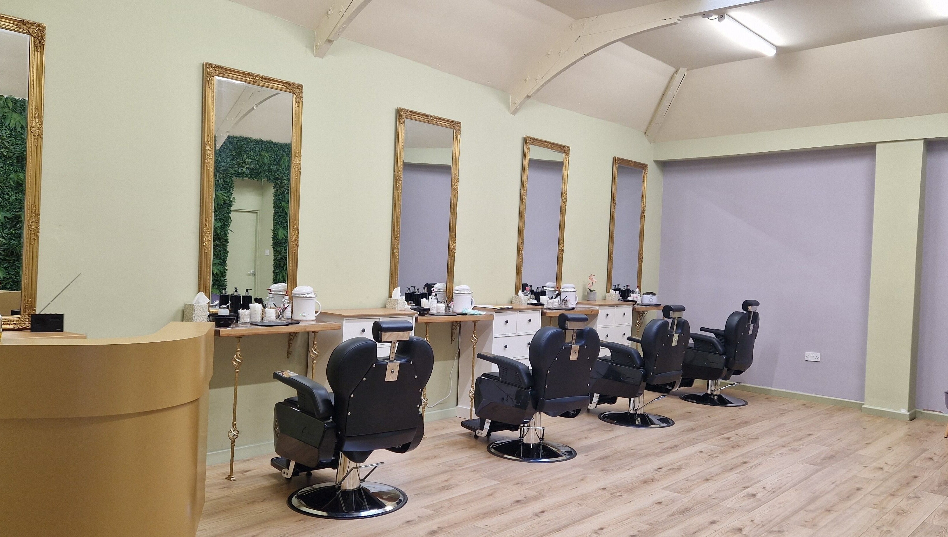 Spacious salon interior at Lia Brow Bar, Newcastle upon Tyne, England, GB with ornate mirrors and modern chairs.