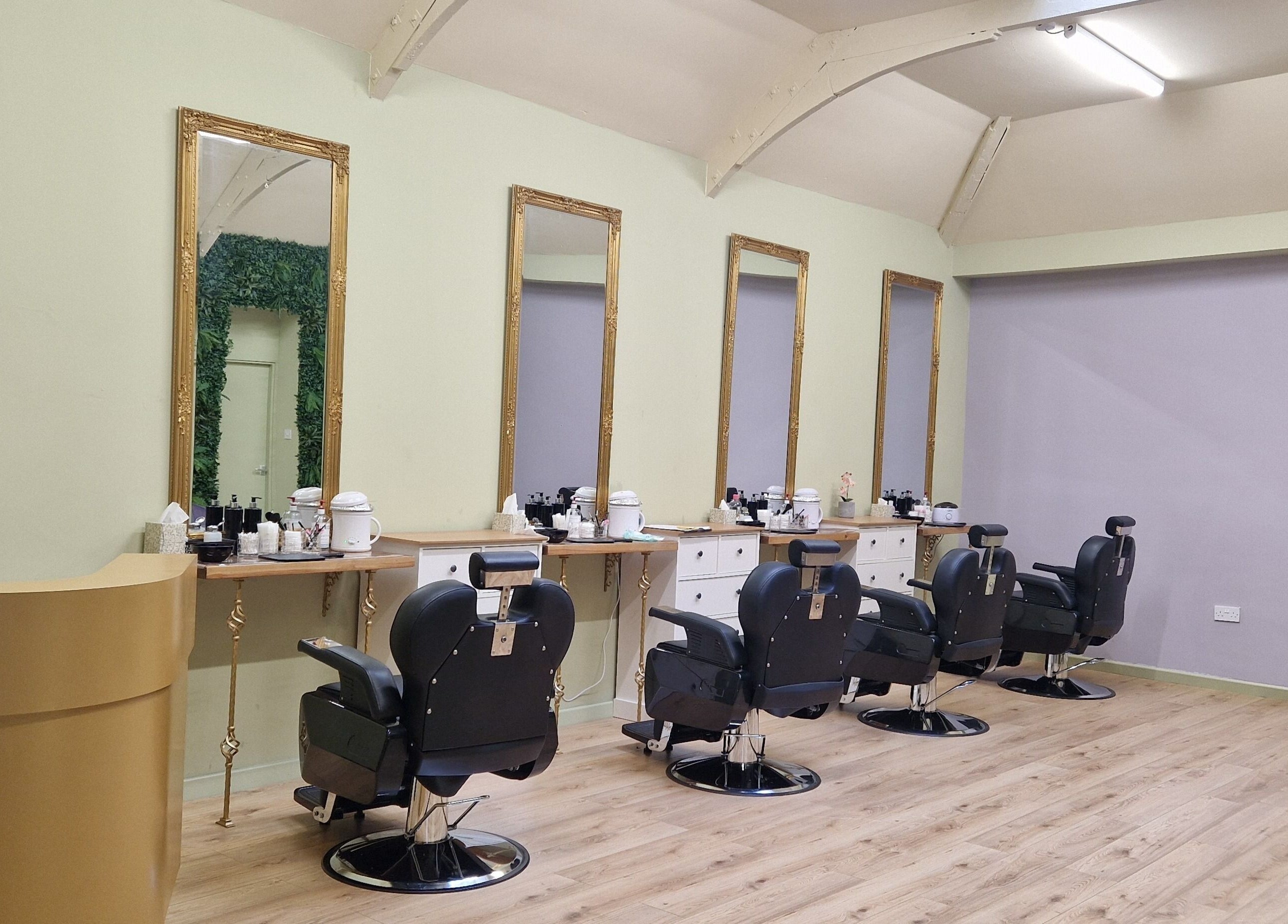 Spacious salon interior at Lia Brow Bar, Newcastle upon Tyne, England, GB with ornate mirrors and modern chairs.