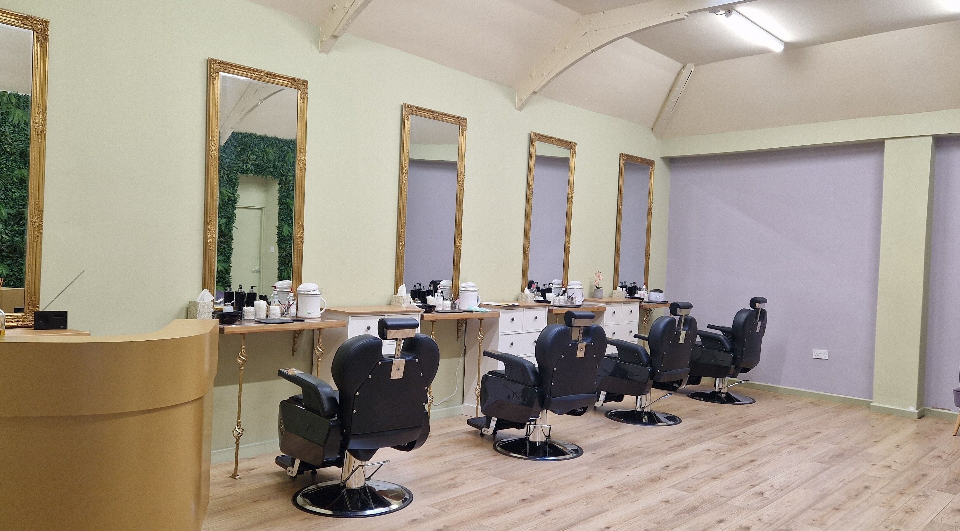 Spacious salon interior at Lia Brow Bar, Newcastle upon Tyne, England, GB with ornate mirrors and modern chairs.