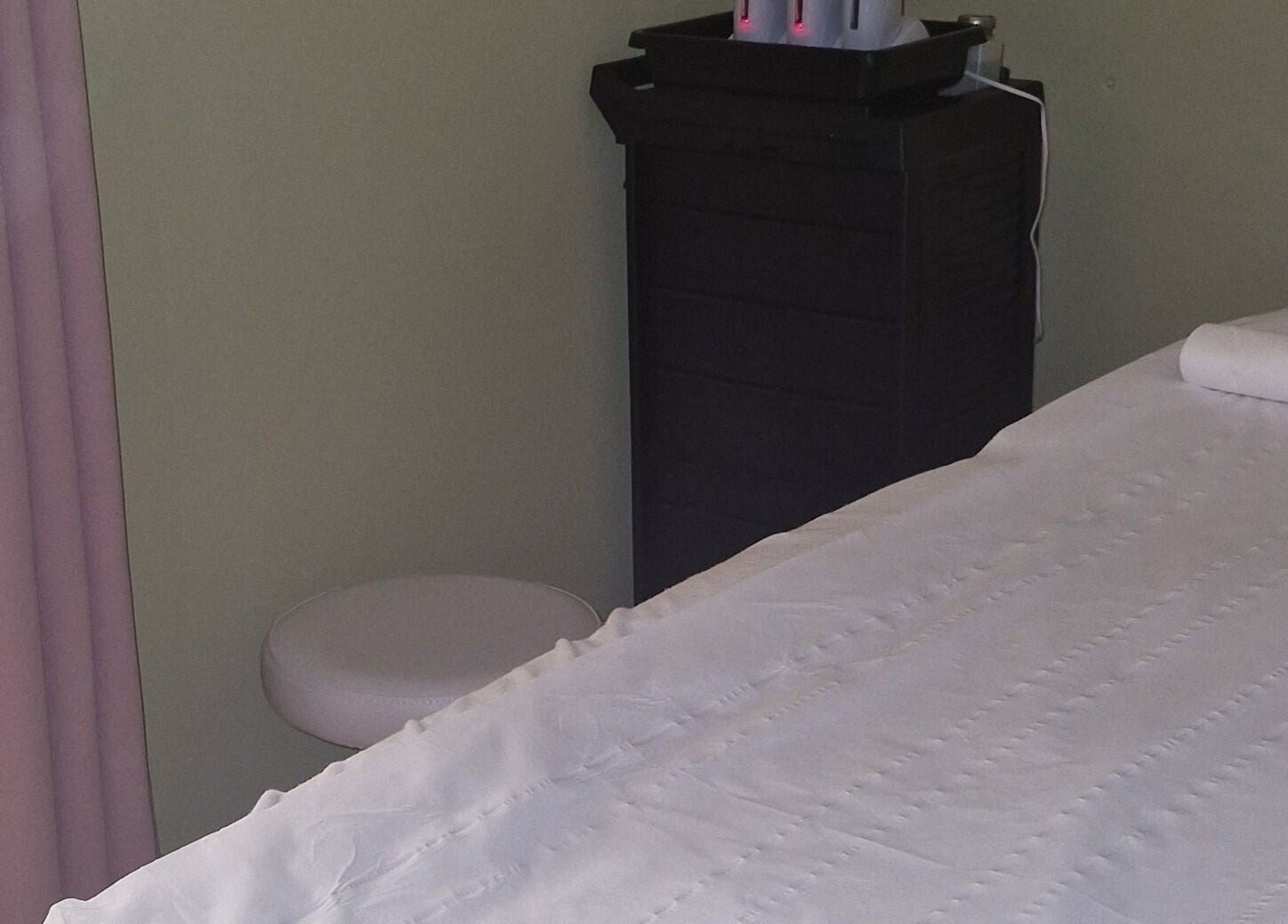 Cozy treatment room at Lia Brow Bar, Newcastle upon Tyne, England, GB with a massage table and warm ambiance.