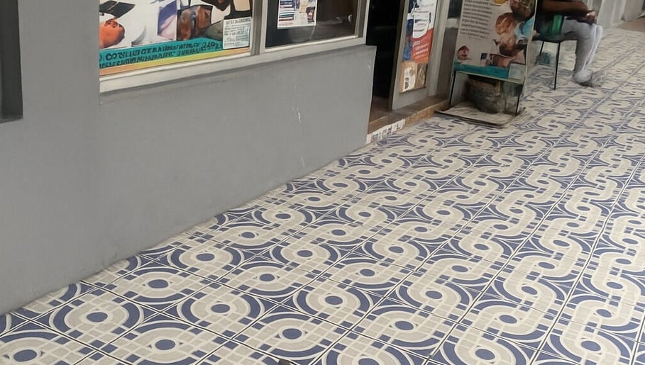 Entrance of Icons Barbershop in Kingston, St. Andrew Parish, JM, featuring elegant patterned tiles.