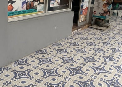 Entrance of Icons Barbershop in Kingston, St. Andrew Parish, JM, featuring elegant patterned tiles.