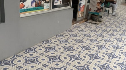Entrance of Icons Barbershop in Kingston, St. Andrew Parish, JM, featuring elegant patterned tiles.