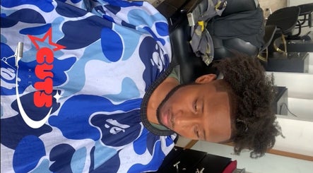 Man with styled hair receiving a haircut at Icons Barbershop, Kingston, St. Andrew Parish, JM.