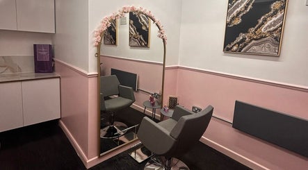 Chic interior of Courtney Louise Hair studio in Northampton, England, featuring a stylish mirror and seating.