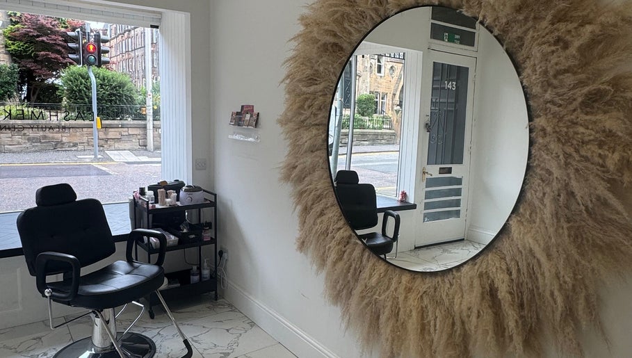 Chic interior of The Brow & Lash Lab ByElle in Edinburgh, Scotland, GB with a decorative mirror and salon chair.