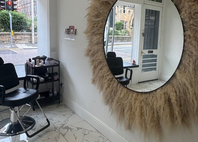 Modern salon chair at The Brow & Lash Lab ByElle, Edinburgh, Scotland, GB with stylish decor.
