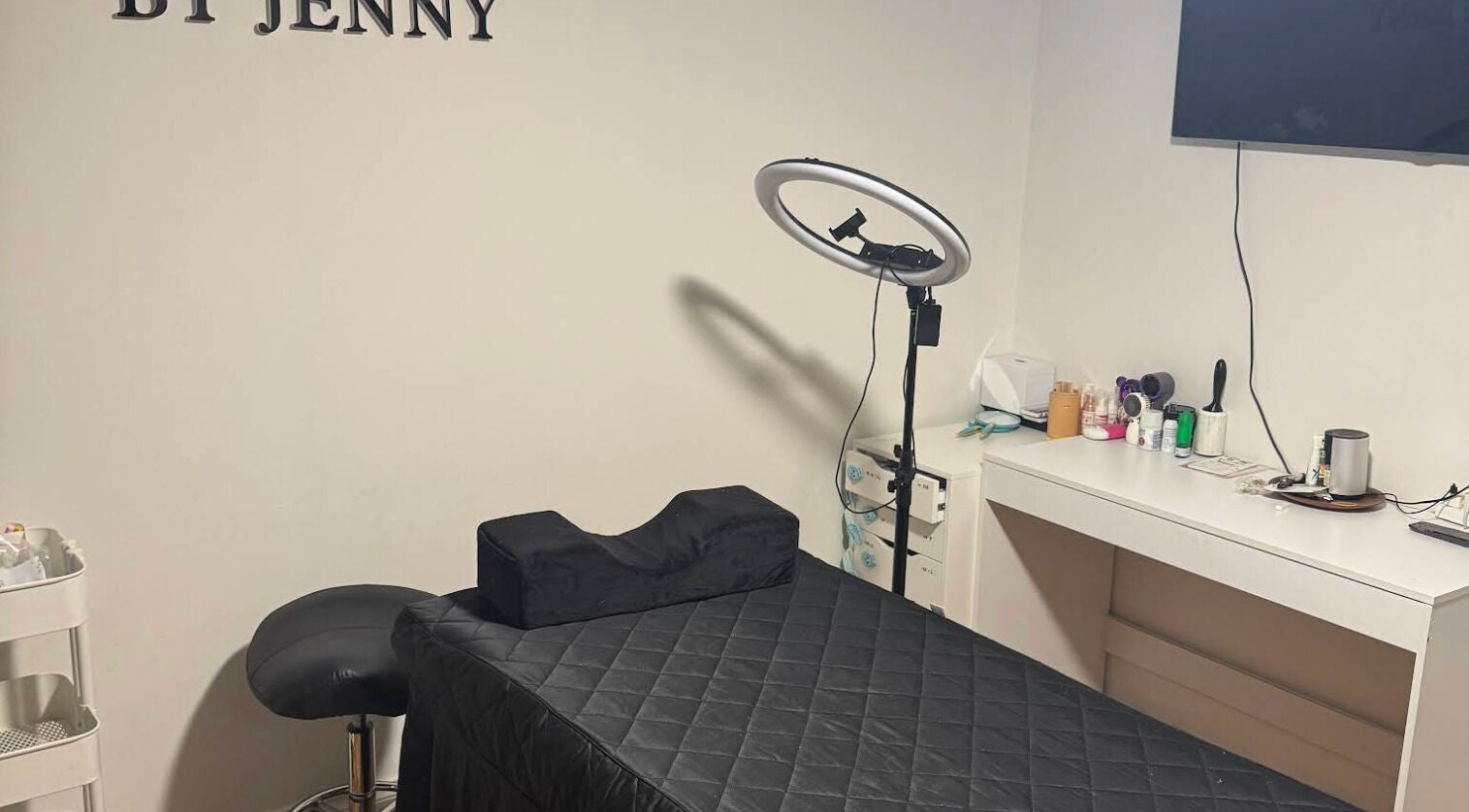 Lash Studio By Jenny's cozy treatment room in Bertram, Western Australia, featuring a cushioned table and beauty tools.