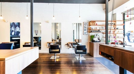 Interior of Spada Hairdressing in Melbourne, Victoria, AU featuring modern styling chairs and product shelves.