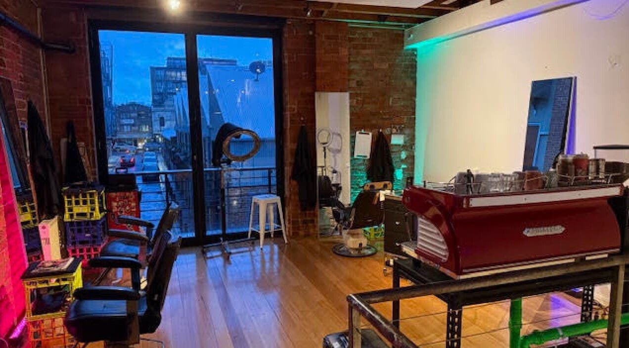 Cozy interior of Hair Agenda in Prahran, Victoria, AU with stylish chairs and modern decor.