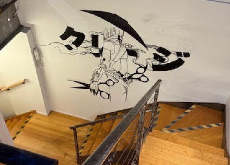 Stylish staircase at Hair Agenda in Prahran, Victoria, AU featuring artistic wall mural.