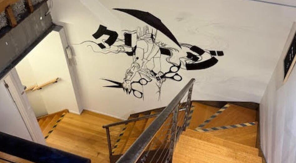 Stylish staircase at Hair Agenda in Prahran, Victoria, AU featuring artistic wall mural.