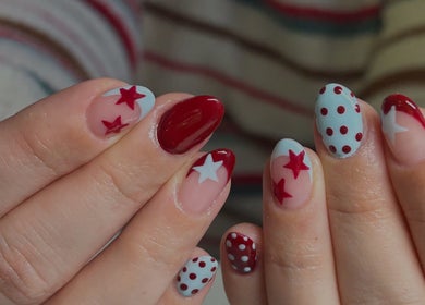 Red and white star-themed nail art at Neash Beauty, Kiama, New South Wales, AU.