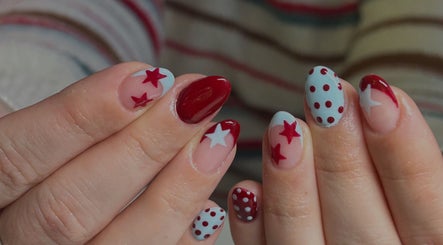 Red and white star-themed nail art at Neash Beauty, Kiama, New South Wales, AU.