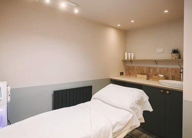 Relaxing treatment room at Cecily Skin Clinic & Koha Aesthetics, Berkhamsted, England, GB, featuring a massage table.