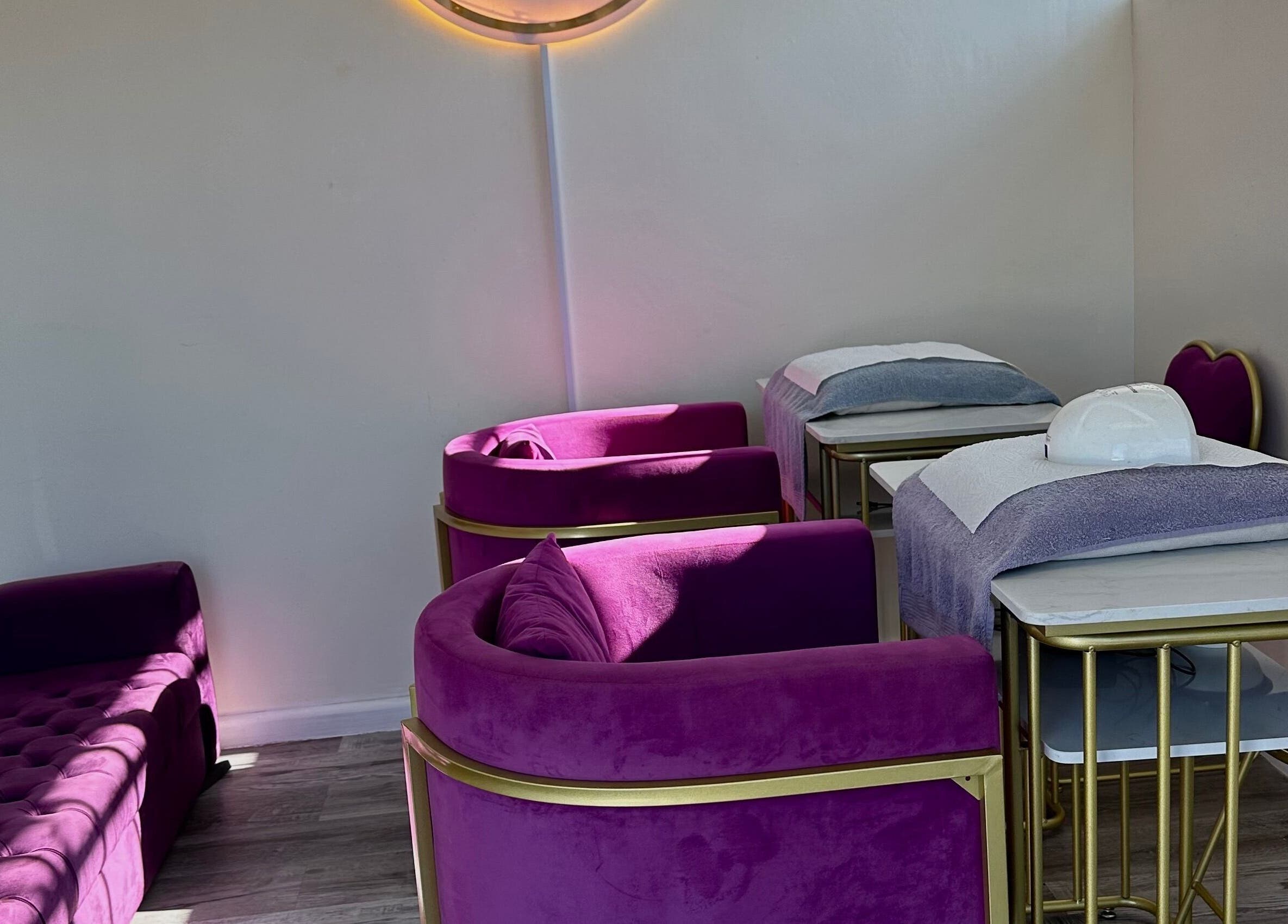 Cozy nail salon area with plush violet chairs at Phezulu beauty and spa, Cape Town, Western Cape, ZA.
