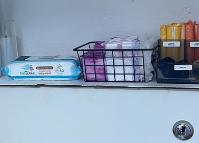 Beauty essentials on display at Lash Me, Hounslow, England, GB featuring wipes, tampons, and hair ties.