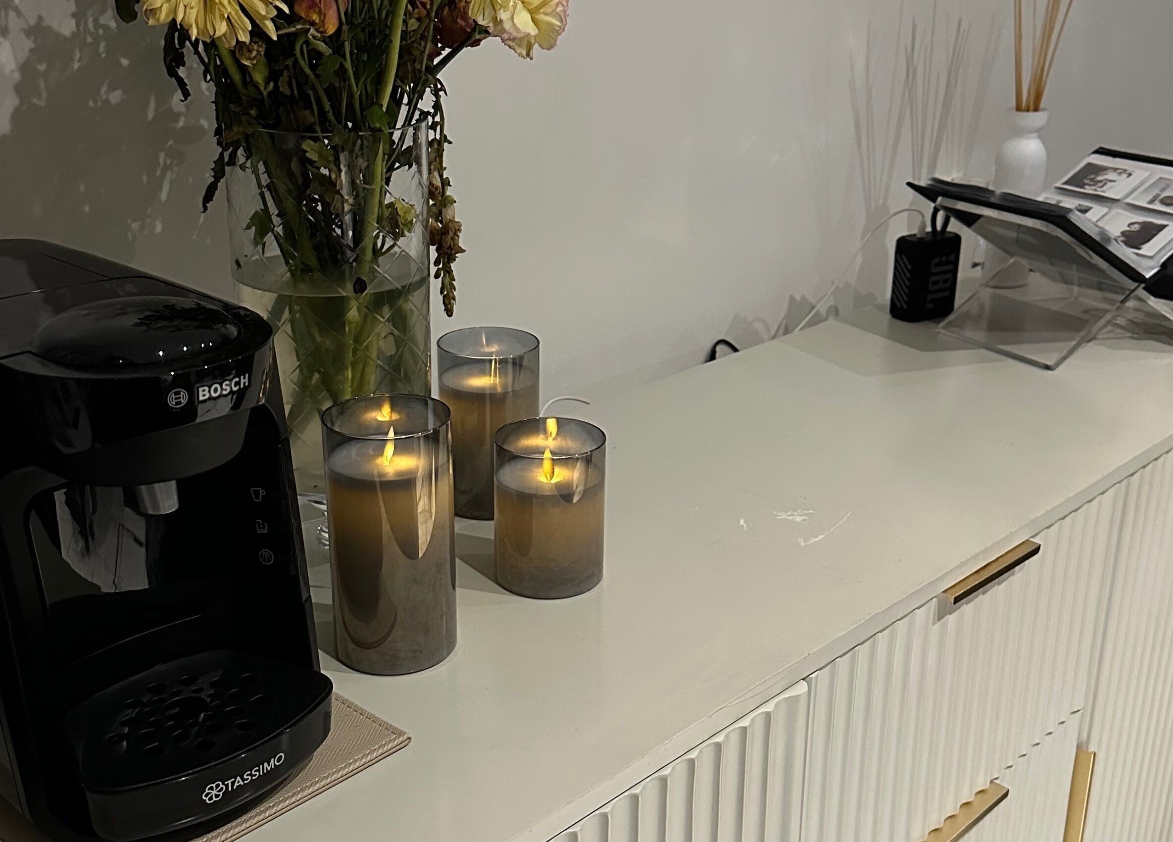 Elegant coffee corner at Lash Me, Hounslow, England, GB with candles and flowers.