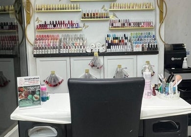 Inspiration Nail, Hair and Beauty salon in Isleworth, England, features a colorful nail polish display.