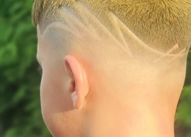 Creative fade haircut design at Ultimate Crown Barber in Forest Hall, England, GB.