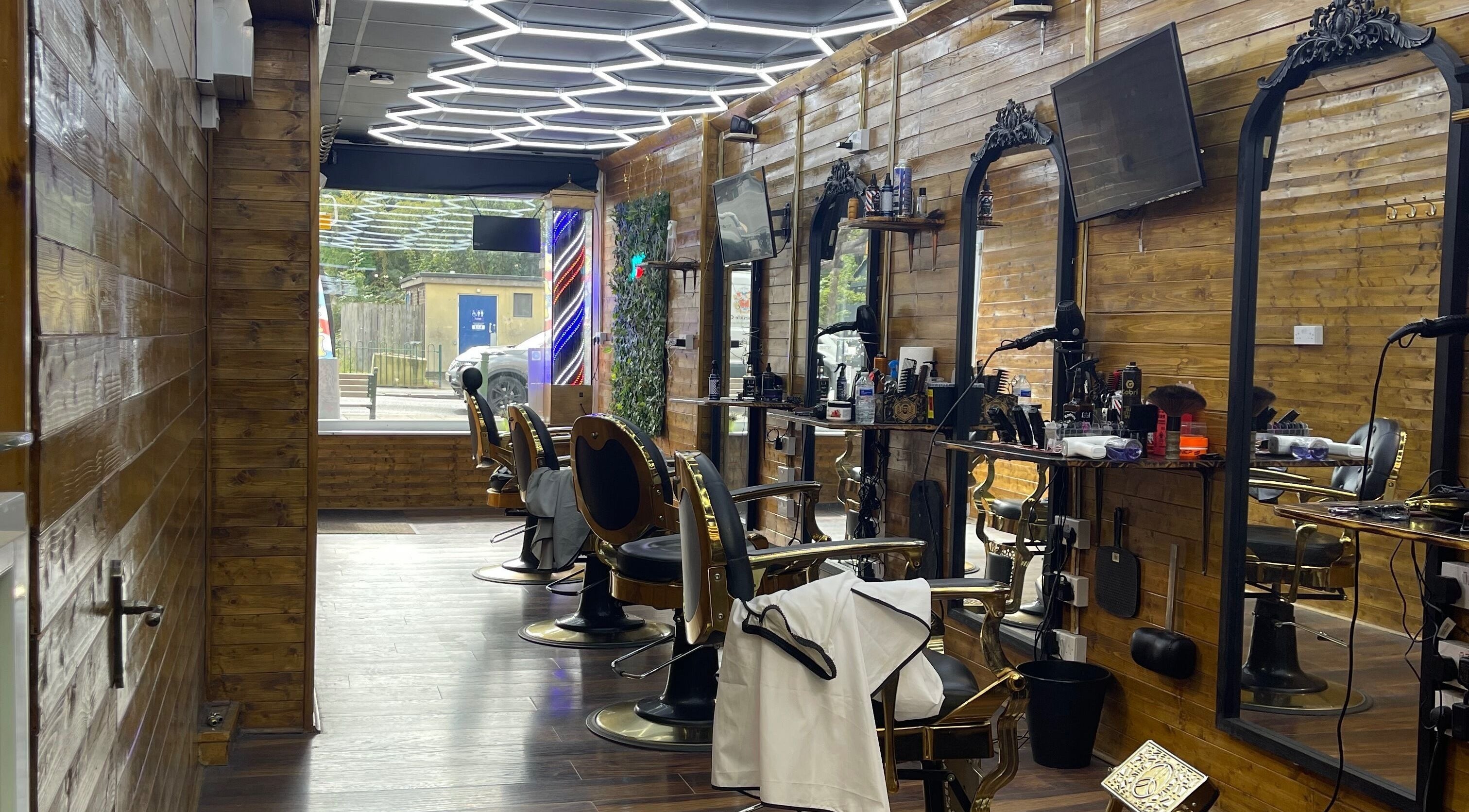 Interior of Ultimate Crown Barber with elegant chairs and mirrors in Forest Hall, England, GB.