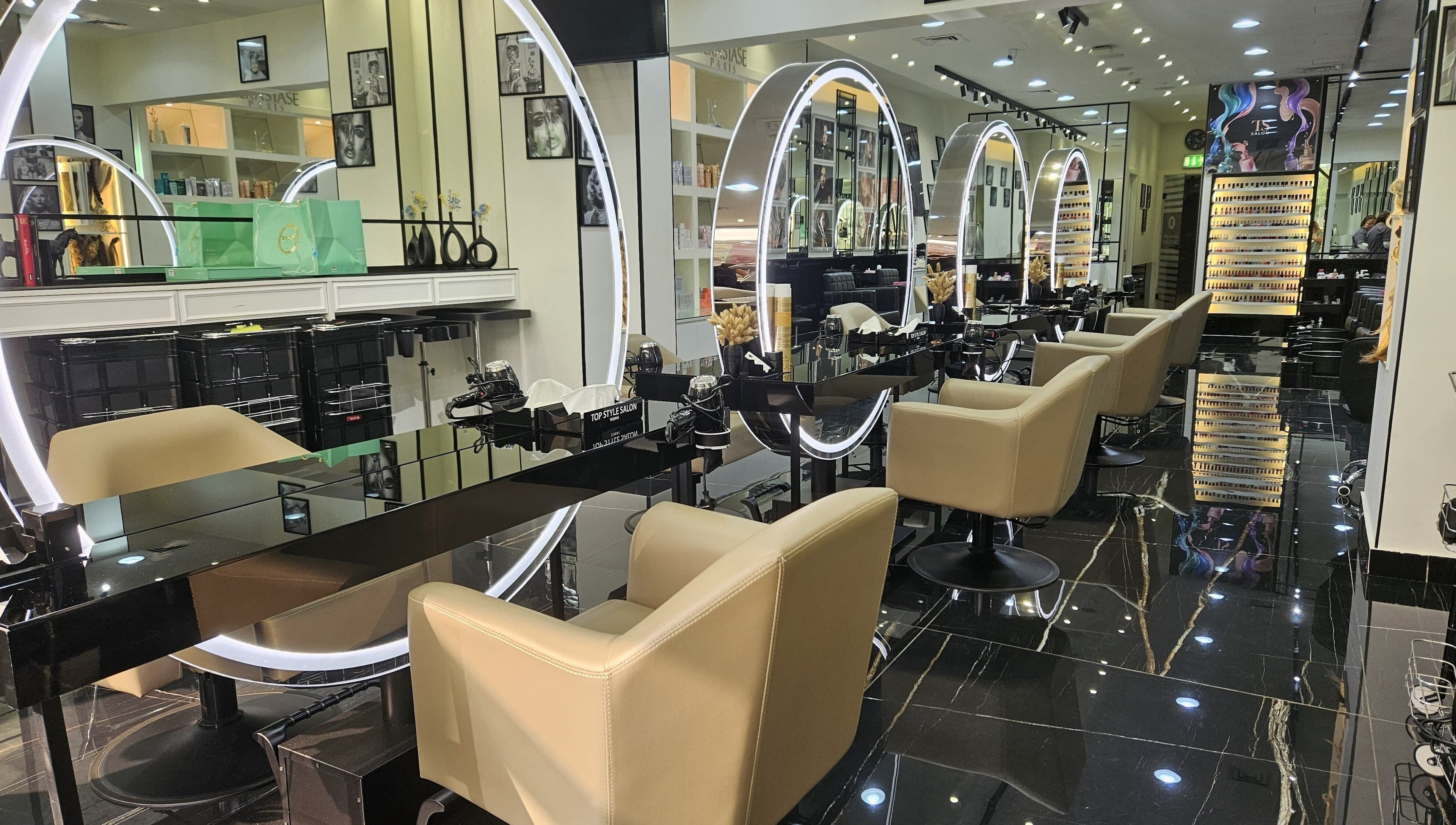 Interior of Top Style Ladies Saloon in Dubai, AE with sleek stations and illuminated mirrors.
