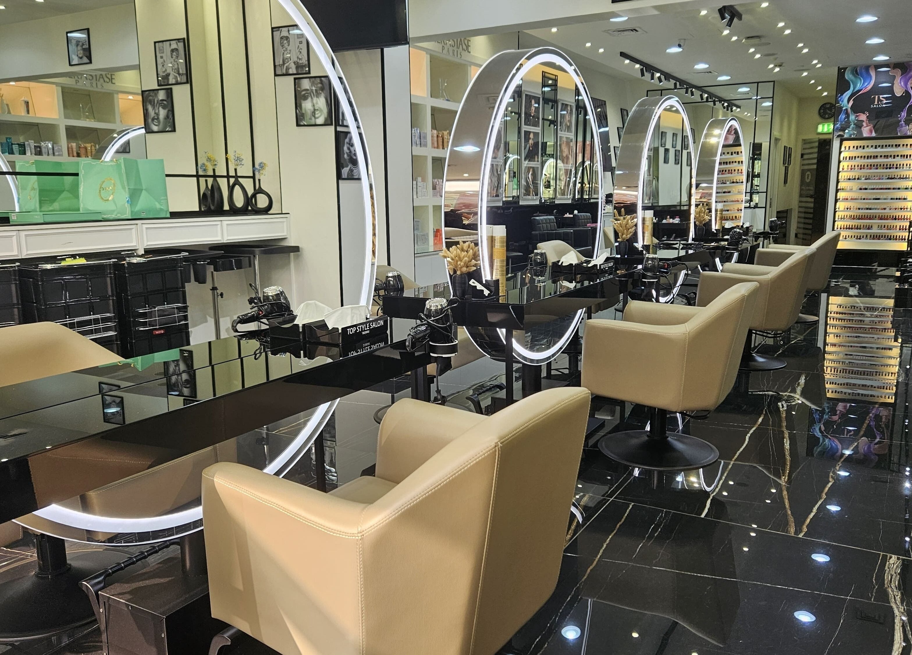 Interior of Top Style Ladies Saloon in Dubai, AE with sleek stations and illuminated mirrors.