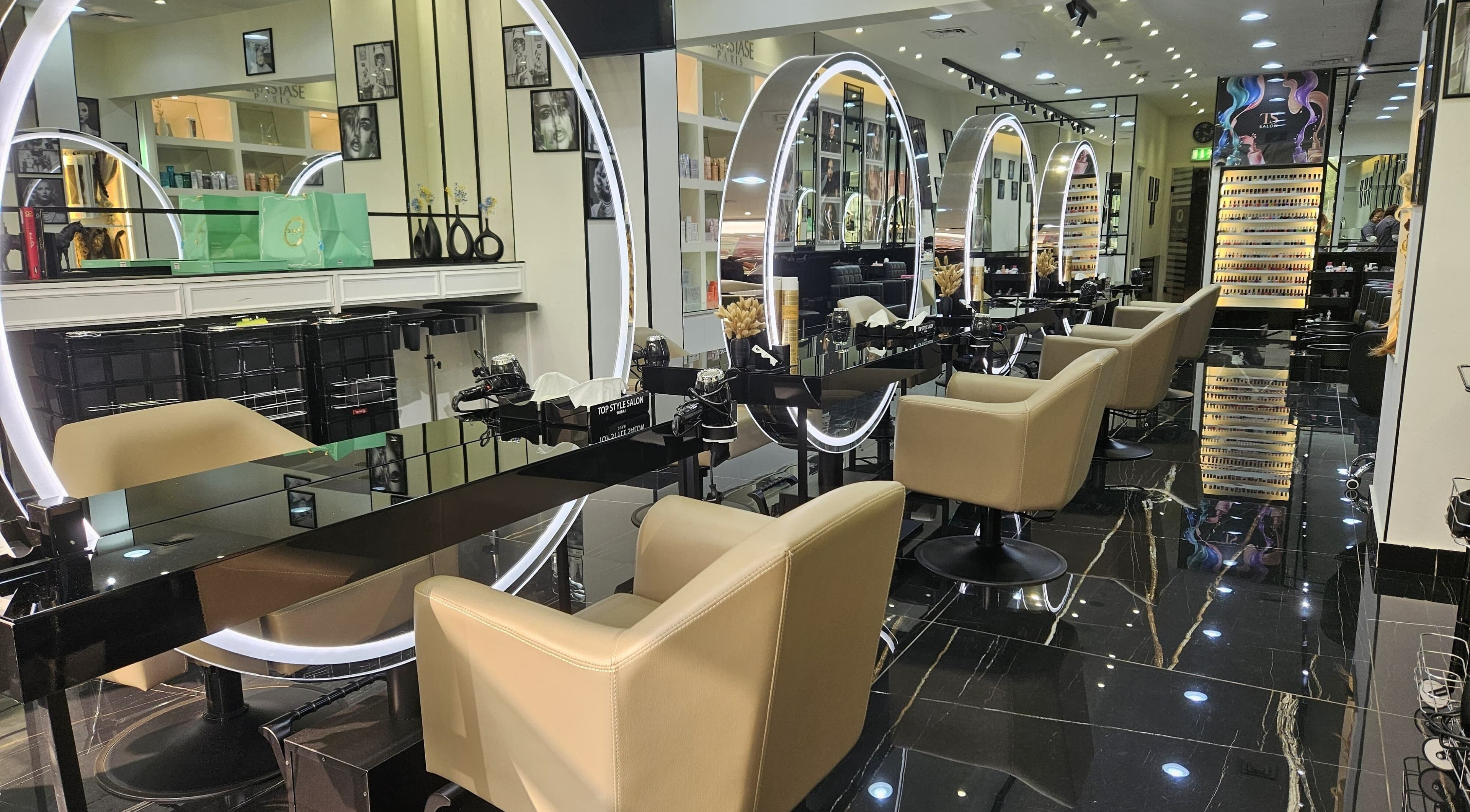Interior of Top Style Ladies Saloon in Dubai, AE with sleek stations and illuminated mirrors.