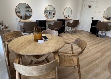 Chic interior of Esthétic Hair salon in Peacehaven, England, GB featuring modern decor and styling stations.