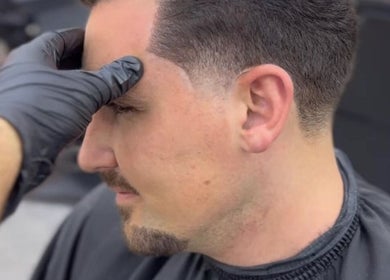 Hair stylist perfecting a man's haircut at Venom Salon, Dubai, Dubai, AE.