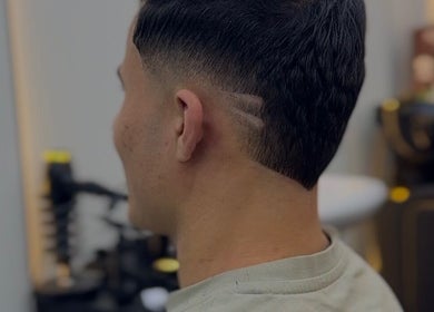 Modern haircut with sharp fade design at Venom Salon, Dubai, Dubai, AE, showcasing expert barbering skills.