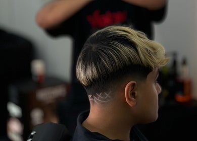 Trendy hairstyle with a fade design at Venom Salon, Dubai, Dubai, AE.