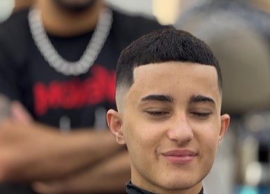 Youthful haircut at Venom Salon, Dubai, Dubai, AE. Close-up of clean fade styling.
