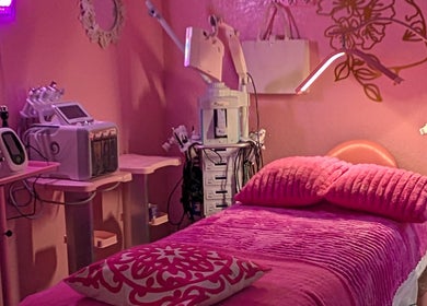 Cozy pink treatment room at Bardon Beauty, Lauderdale-by-the-sea, Florida. Modern equipment and plush bedding showcased.