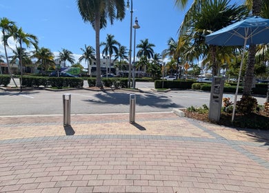 Scenic entrance view of Bardon Beauty in Lauderdale-by-the-sea, Florida, US with palm trees and walkway.