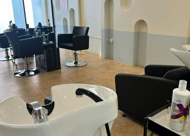 Spacious and modern interior of La Finesse Salon in Al Khobar, Eastern Province, SA with stylish black chairs.