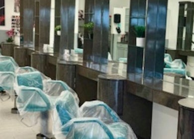 Bright, modern salon chairs at Bis M Salon & Aiza, Orlando, Florida, US offer a stylish, inviting ambiance.