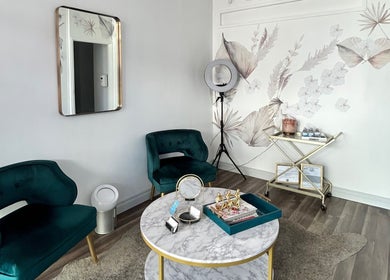 Chic sitting area at Opal Glow & Co., Long Beach, California, US with plush chairs and artistic decor.
