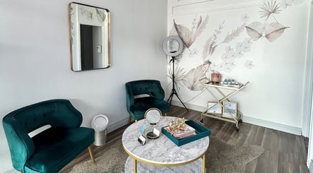 Chic sitting area at Opal Glow & Co., Long Beach, California, US with plush chairs and artistic decor.