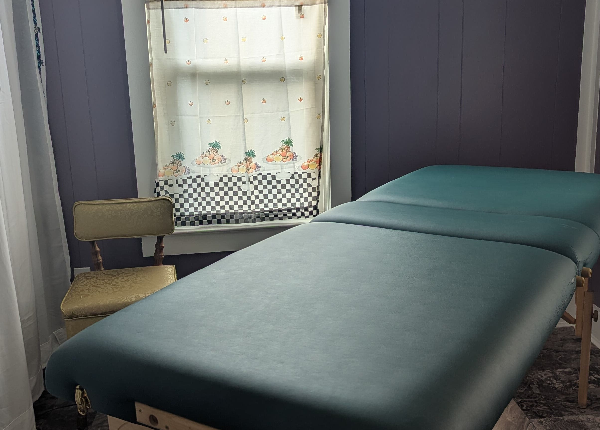 Peaceful treatment room at Waxed Fruit Studio LLC, Endicott, New York, US, featuring a comfortable massage table.