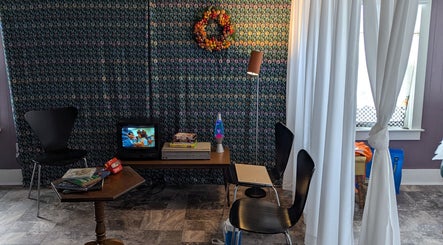 Relaxing corner with TV and decor at Waxed Fruit Studio LLC in Endicott, New York, US.
