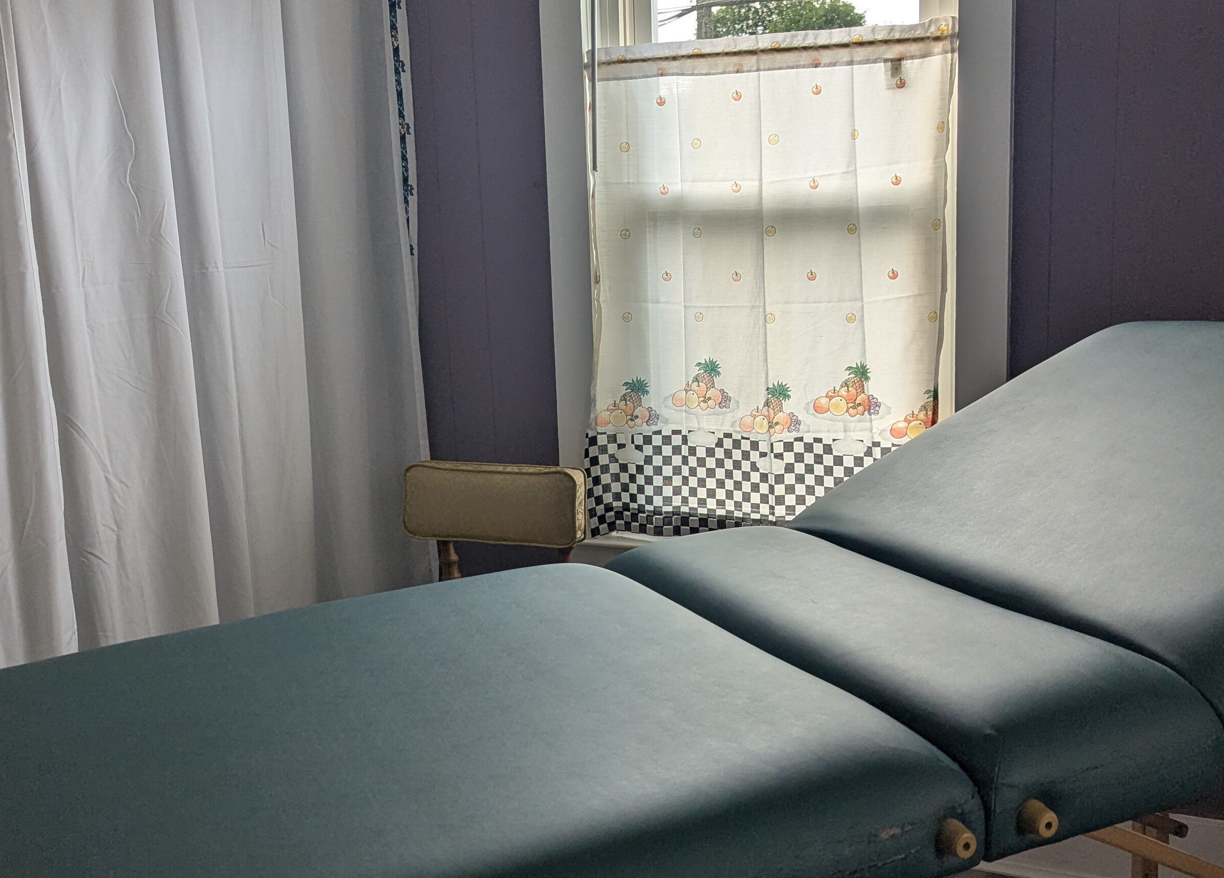 Cozy massage room at Waxed Fruit Studio LLC, Endicott, New York, US with a relaxing massage table.