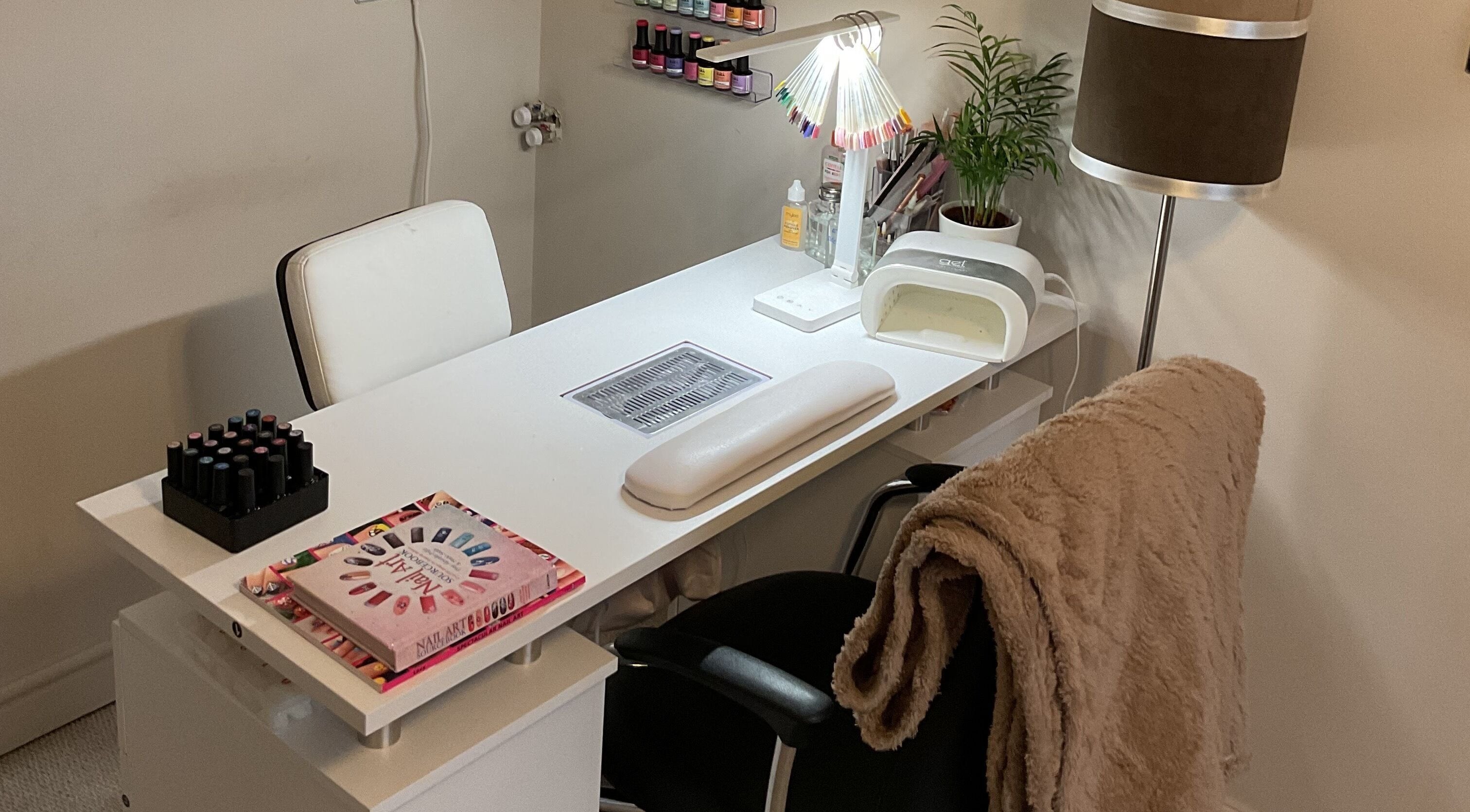 Nail care station at KH Beauty & Body Studio, Mosborough, England, GB, featuring neatly organized polish and tools.