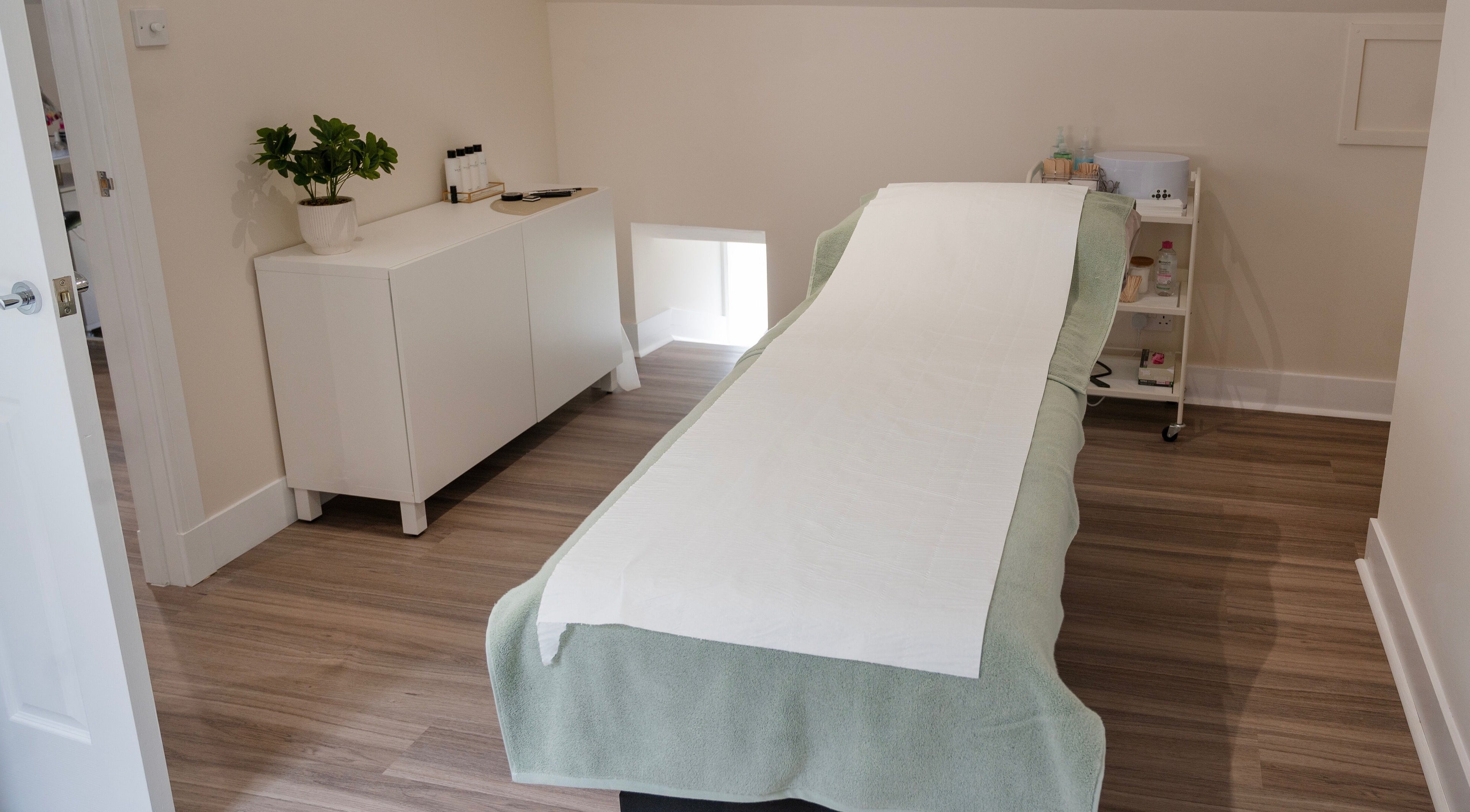Serene treatment room at Defining Beauty, Aboyne, Scotland, GB, featuring a massage table and soothing decor.
